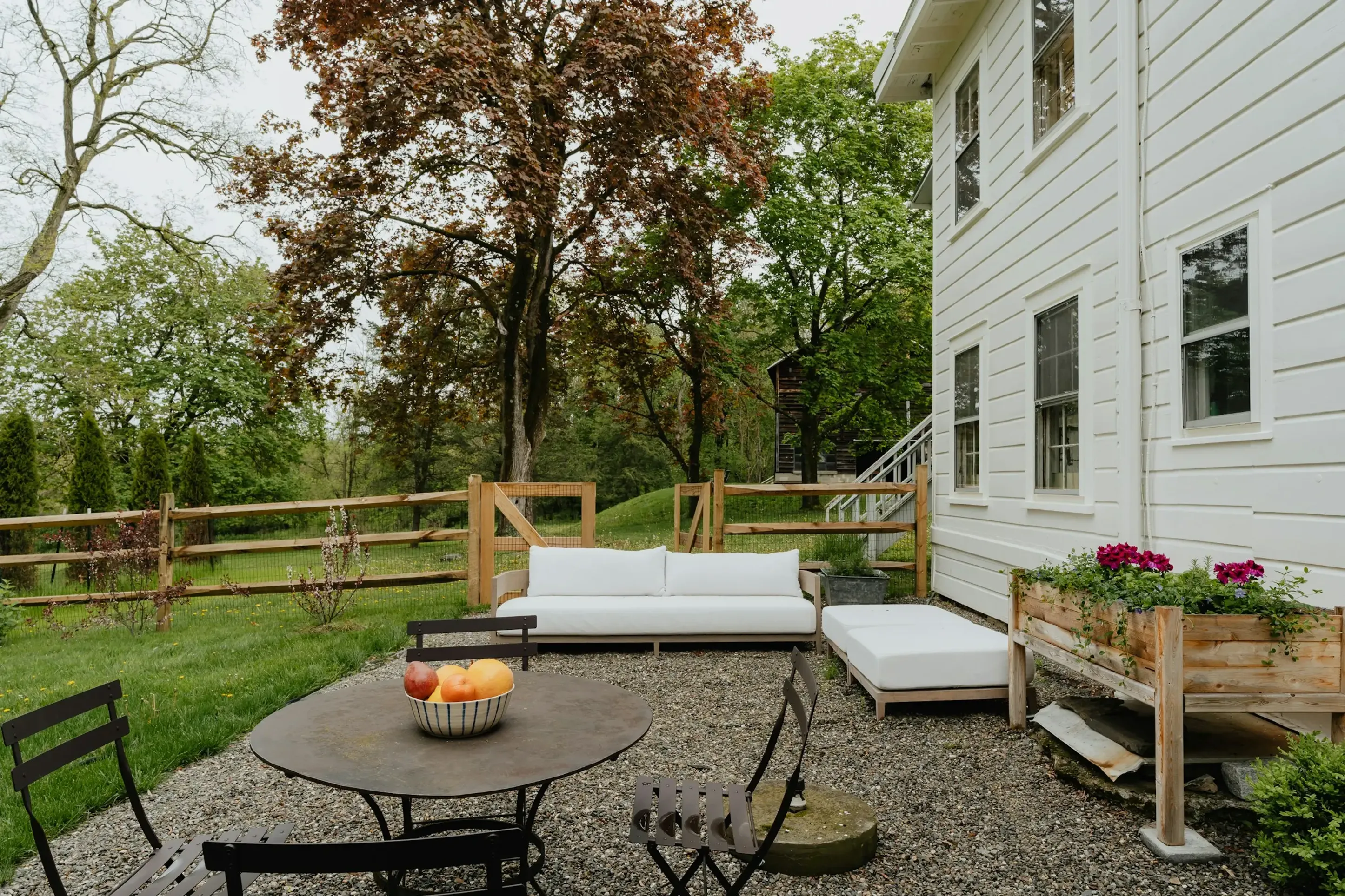 Outdoor furniture patio scene with dining table, chairs, and sectional sofa